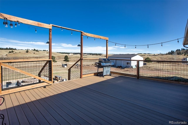 wooden deck featuring area for grilling and a rural view