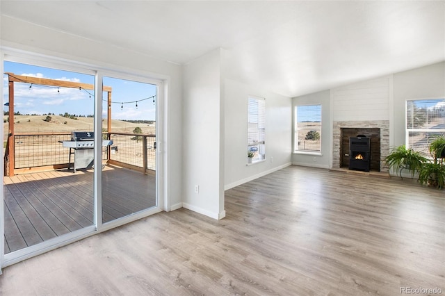 unfurnished living room featuring plenty of natural light and wood-type flooring