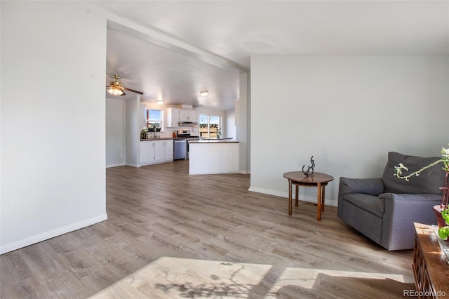 interior space with ceiling fan and light hardwood / wood-style flooring