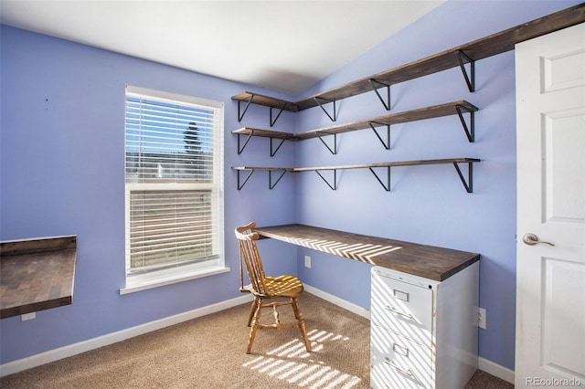 carpeted office with vaulted ceiling