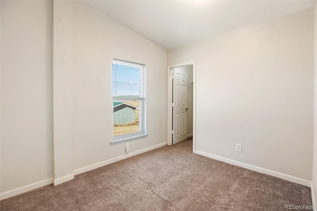 empty room with carpet and lofted ceiling