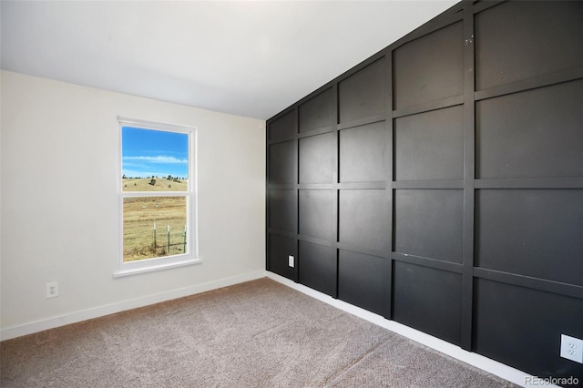 carpeted spare room featuring lofted ceiling