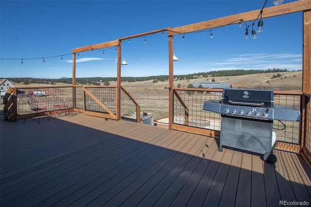 wooden terrace with grilling area and a rural view