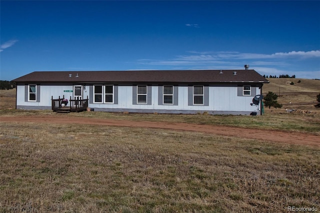 rear view of house featuring a lawn