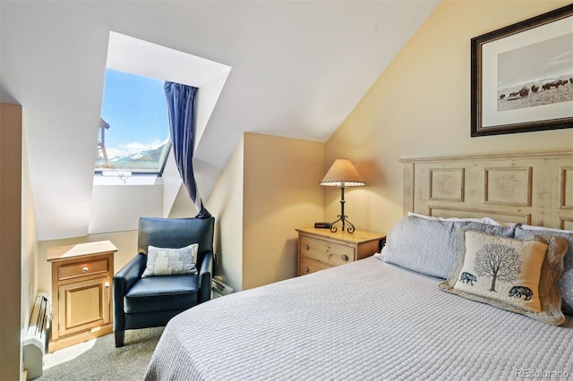 carpeted bedroom with lofted ceiling and a baseboard heating unit