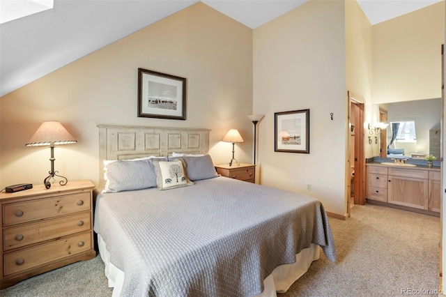 carpeted bedroom featuring connected bathroom and vaulted ceiling