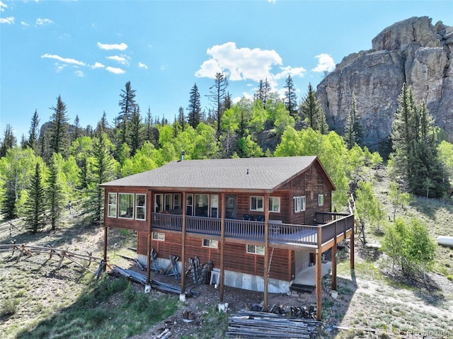 305 Travois Ct, Como, CO 80432 - rear view of property featuring a view of trees, a wooden deck, and a shingled roof
