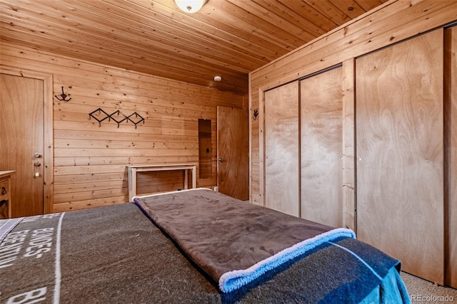 305 Travois Ct, Como, CO 80432 - carpeted bedroom featuring wooden ceiling, wood walls, and a closet