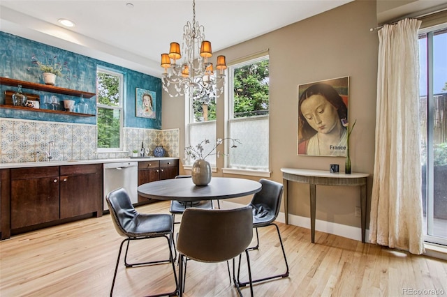 340 S Lafayette St Unit 204, Denver, CO 80209 - dining space with light wood finished floors, a chandelier, and healthy amount of natural light