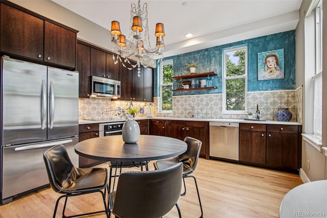 340 S Lafayette St Unit 204, Denver, CO 80209 - kitchen featuring stainless steel appliances, light wood-style flooring, dark brown cabinetry, light countertops, and recessed lighting
