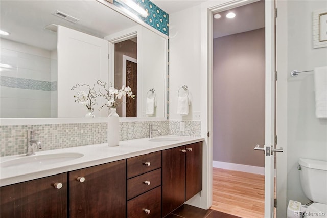 340 S Lafayette St Unit 204, Denver, CO 80209 - full bath featuring double vanity, tasteful backsplash, wood finished floors, and recessed lighting
