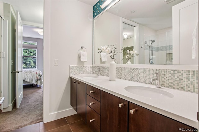 340 S Lafayette St Unit 204, Denver, CO 80209 - full bath with tile patterned flooring, decorative backsplash, double vanity, tiled shower, and ensuite bath