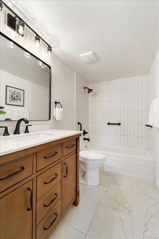 13902 E Marina Dr Unit 202, Aurora, CO 80014 - bathroom with vanity, bathtub / shower combination, marble look tiles, and a textured ceiling