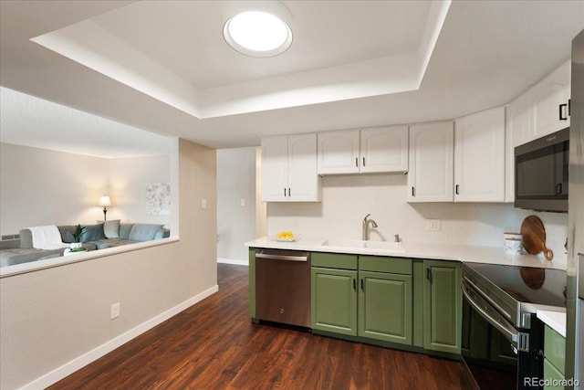 13902 E Marina Dr Unit 202, Aurora, CO 80014 - kitchen with stainless steel appliances, a tray ceiling, green cabinets, white cabinets, and dark wood-style floors