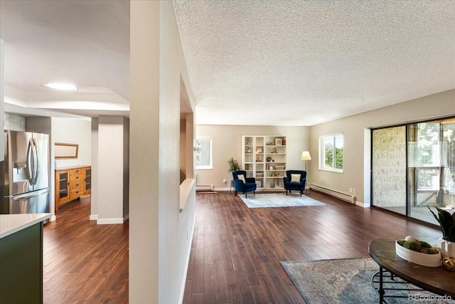 13902 E Marina Dr Unit 202, Aurora, CO 80014 - living area featuring a baseboard radiator, dark wood-style floors, baseboard heating, a textured ceiling, and built in shelves