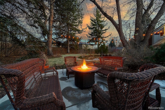 patio terrace at dusk featuring a fire pit