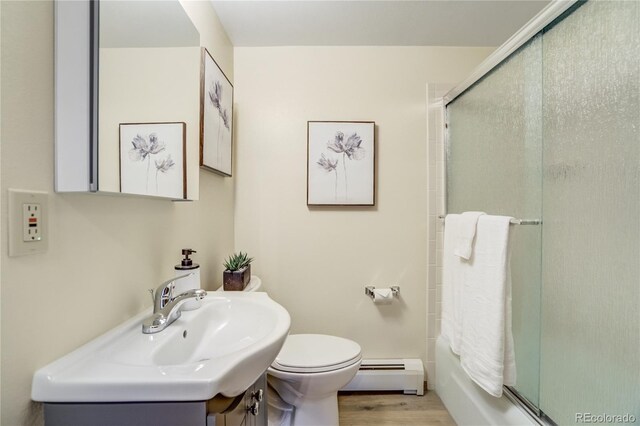 9610 Mohawk Trl, Cascade, CO 80809 - full bath featuring a baseboard radiator, toilet, vanity, and wood finished floors