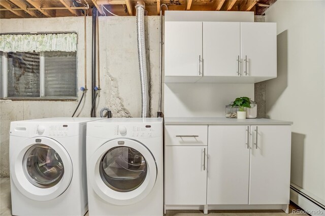9610 Mohawk Trl, Cascade, CO 80809 - clothes washing area featuring a baseboard heating unit, washer and clothes dryer, and cabinet space