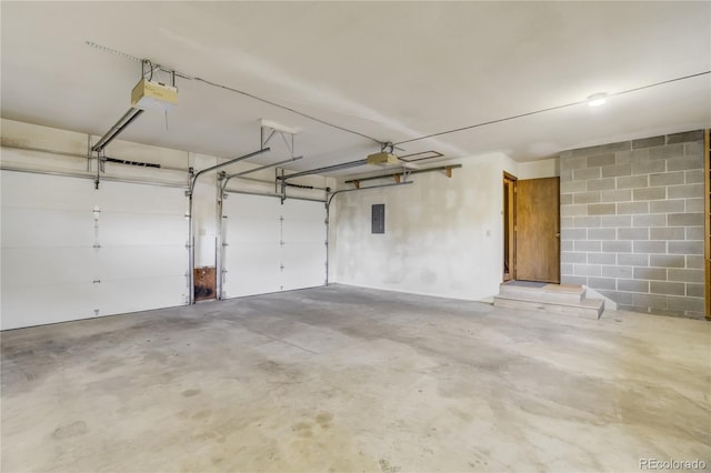 9610 Mohawk Trl, Cascade, CO 80809 - garage with electric panel, a garage door opener, and concrete block wall