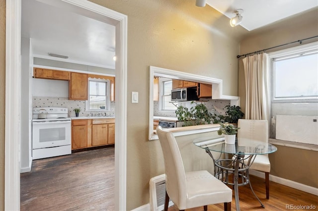 kitchen featuring tasteful backsplash, dark wood-type flooring, and white electric range