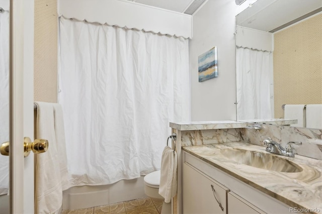 full bathroom with vanity, toilet, and shower / bath combo