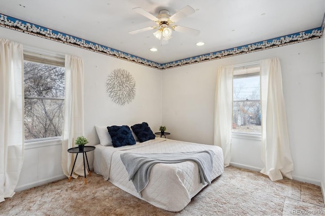 bedroom featuring ceiling fan and light carpet