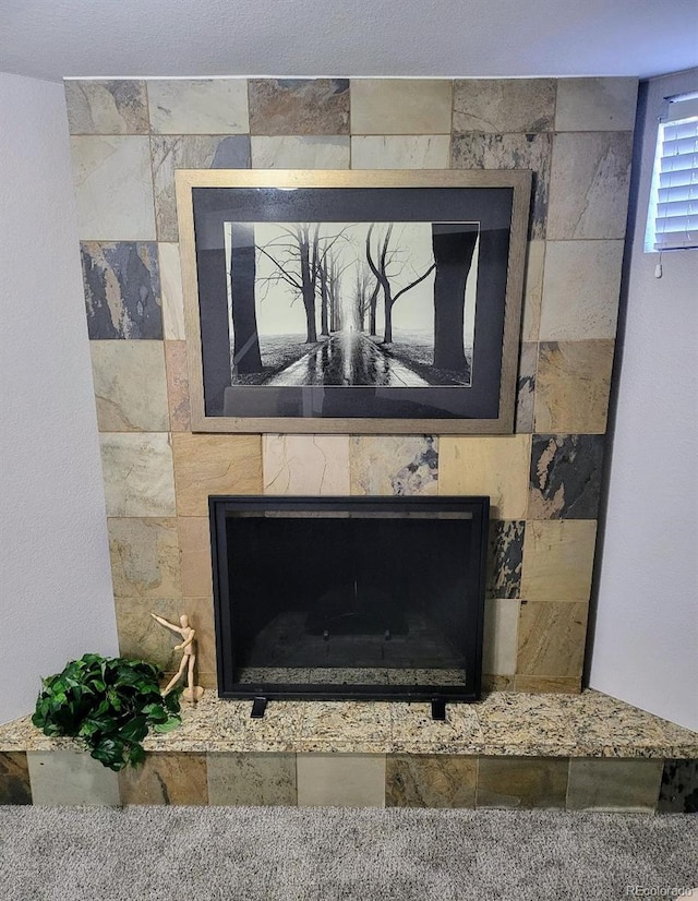 interior details with a tile fireplace