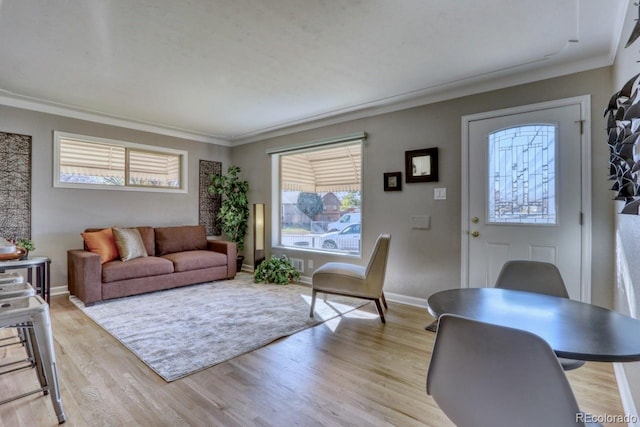 living room with crown molding and light hardwood / wood-style floors