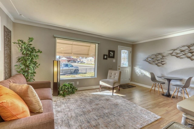 living area with ornamental molding and light wood-type flooring