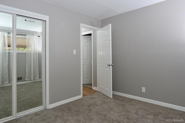 unfurnished bedroom featuring carpet and a closet