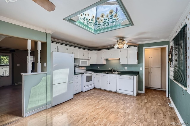 5673 Johnson St, Arvada, CO 80002 - kitchen with white appliances, ceiling fan, dark countertops, light wood finished floors, and white cabinetry