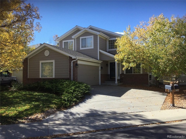 13674 Plaster Cir, Broomfield, CO 80023 - view of front of house with brick siding, concrete driveway, and a garage