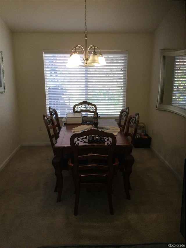 dining room featuring a chandelier, carpet floors, and plenty of natural light