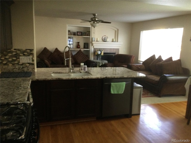 13674 Plaster Cir, Broomfield, CO 80023 - kitchen with a sink, a peninsula, light wood-type flooring, and light stone countertops
