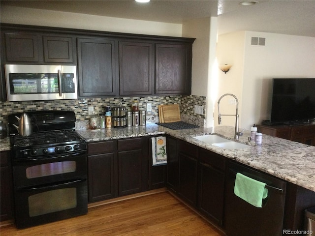 13674 Plaster Cir, Broomfield, CO 80023 - kitchen featuring stainless steel microwave, double oven range, a sink, and light stone countertops