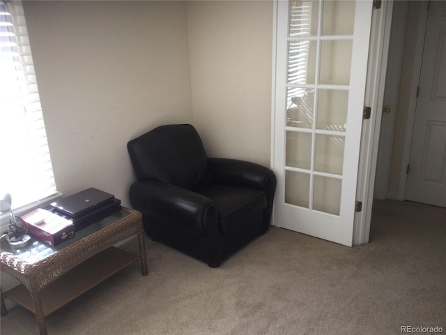 sitting room featuring light colored carpet