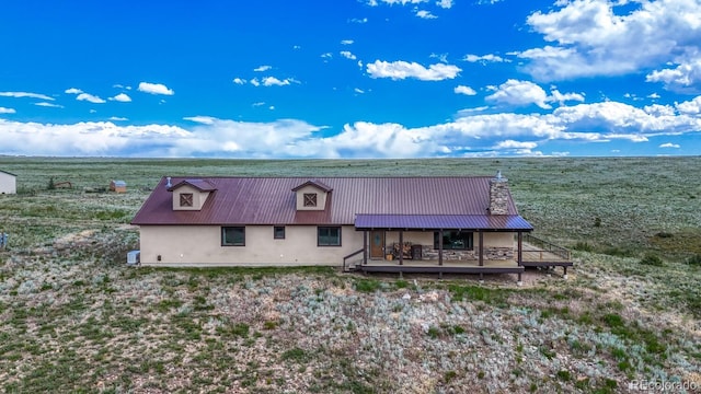 1610 Timber Ridge Rd, Westcliffe, CO 81252 - rear view of house with a metal roof, a wooden deck, and stucco siding