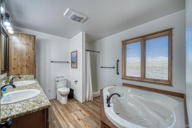 1610 Timber Ridge Rd, Westcliffe, CO 81252 - bathroom with a tub with jets, double vanity, wood finished floors, and a shower with shower curtain
