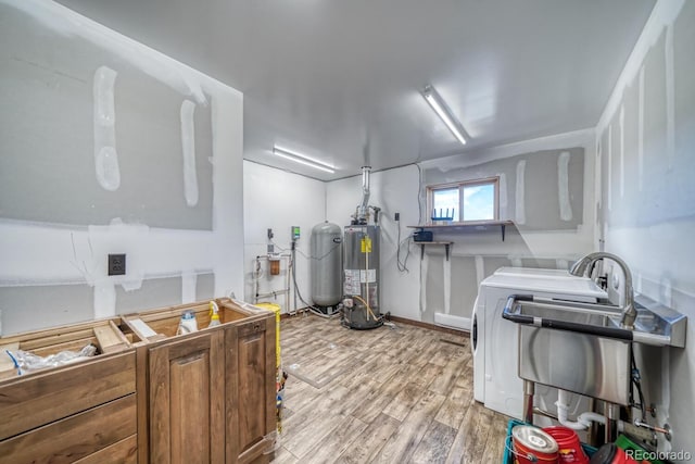 1610 Timber Ridge Rd, Westcliffe, CO 81252 - kitchen with water heater, light wood-type flooring, independent washer and dryer, and brown cabinets