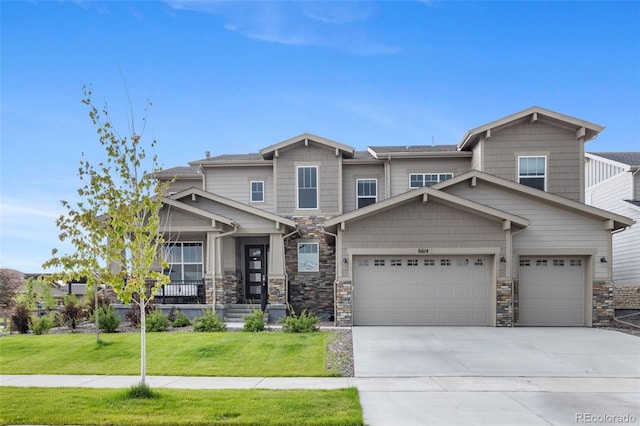 6614 S Vandriver Way, Aurora, CO 80016 - craftsman-style home with a front lawn, driveway, stone siding, and a garage