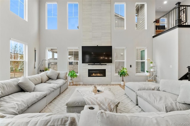 6614 S Vandriver Way, Aurora, CO 80016 - living room featuring a high ceiling, plenty of natural light, and a fireplace