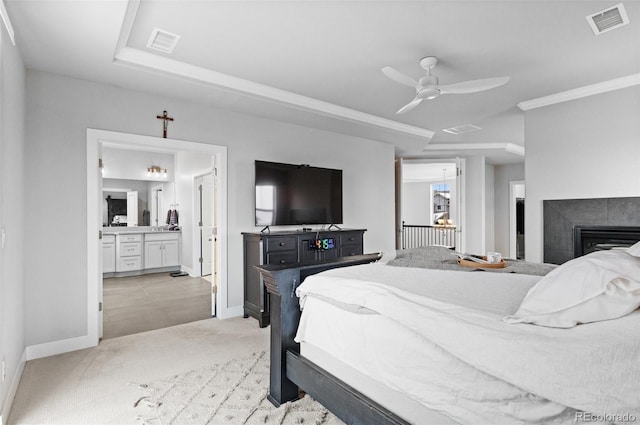 6614 S Vandriver Way, Aurora, CO 80016 - bedroom with light carpet, a tile fireplace, ensuite bath, and a ceiling fan