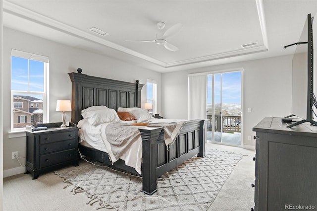 6614 S Vandriver Way, Aurora, CO 80016 - bedroom featuring a tray ceiling, light colored carpet, access to exterior, and a ceiling fan
