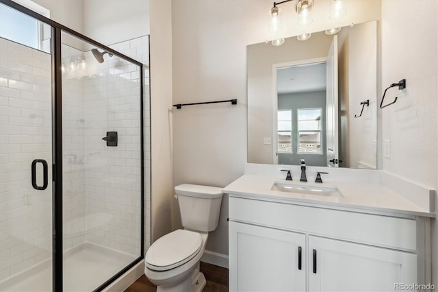 full bathroom with a shower stall, toilet, and vanity