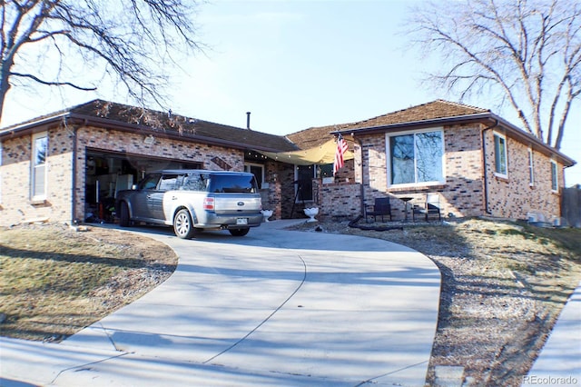 ranch-style home with a garage, brick siding, and driveway