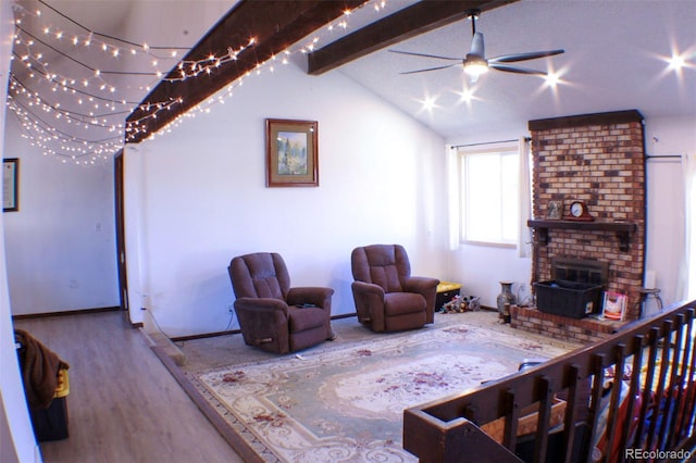 living area with vaulted ceiling with beams, wood finished floors, a ceiling fan, and baseboards