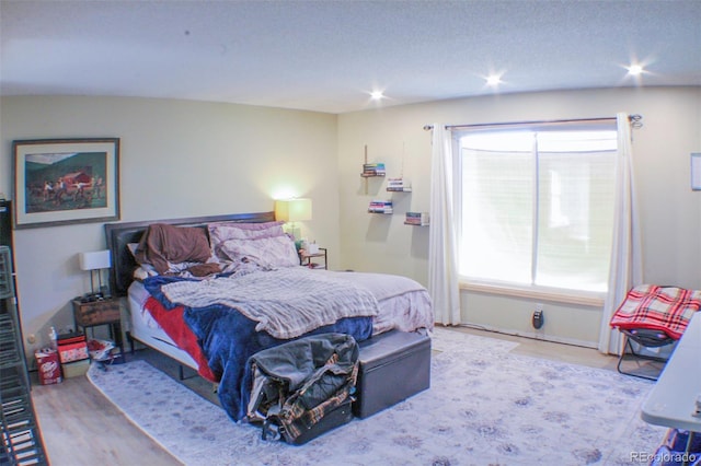 bedroom featuring wood finished floors and recessed lighting