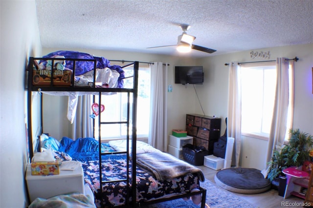 bedroom featuring a ceiling fan and a textured ceiling