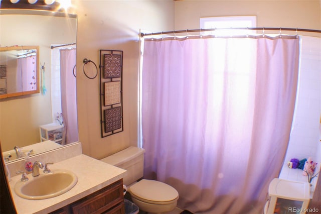 full bath featuring vanity and toilet