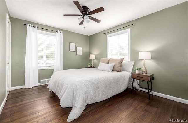 6390 W 45th Ave, Wheat Ridge, CO 80033 - bedroom with multiple windows, dark wood-style floors, and ceiling fan